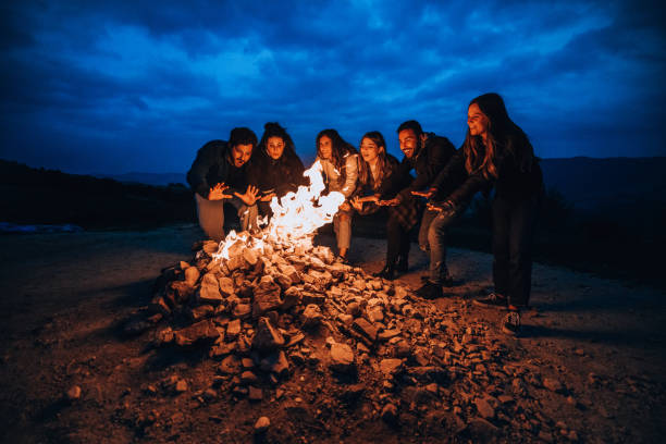 istock Friends having fun around a fireplace 1716595722