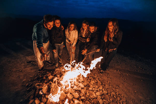 istock Friends having fun around a fireplace 1716595784