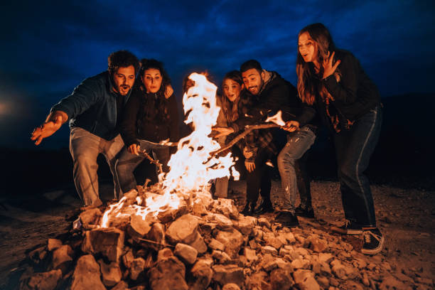 istock Friends having fun around a fireplace 1716595882
