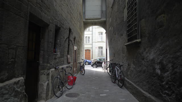 Fribourg, Switzerland Circa March 2022 - ancient back alley in Swiss city with bicycles at rest