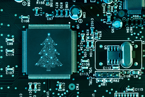 Artificial intelligence christmas tree computer chip concept on circuit board. This file is cleaned and retouched.