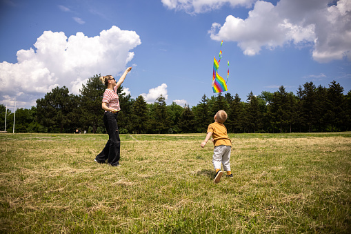 Indoor, happy family day. Single mother with toddler. Spending time in fun and games outdoor.