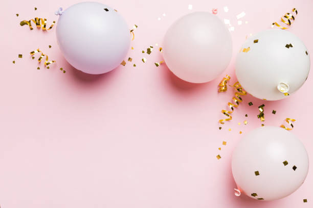 istock Background with fastive air balloons of round shape and confetti, multicoloured top view. Birthday party background 1716637056