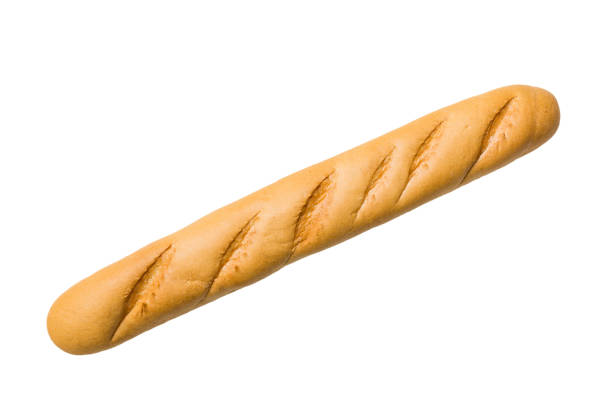 Close-up of freshly baked golden brown French baguettes with a light dusting of flour, showcasing artisanal bread texture and crust pattern.