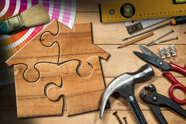 istock Home Improvement Concept - Work Tools and Wooden Model House 1716660565