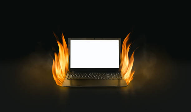 istock Black laptop computer with burning fire in dark background, computer laptop with copy space on white blank screen for text 1716689434