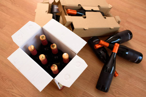 istock Cardboard box with quality wine bottles sent by post 1716691086