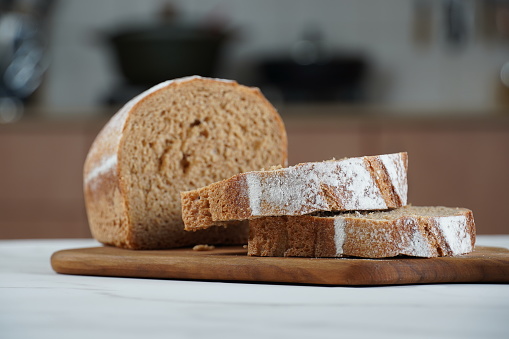 Sliced rye bread on cutting board. Whole grain rye bread