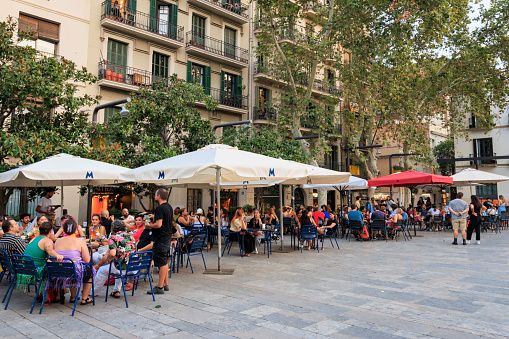 Barcelona, Spain - September 16, 2023: A traditional public plaza in a central part of the city with bars and restaurants.