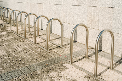 Bars to park  bicycles, empty, installed at the entrance of a building.