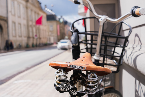 Copenhagen, Denmark - August 8, 2023: Detail of a leather bike saddle, Brooks brand