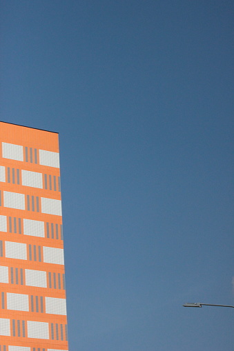 Part of a multi-storey building on a blue sky background