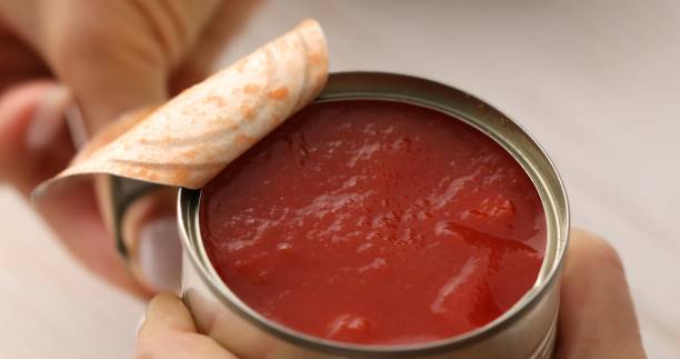 Opening a can of chopped Italian tomatoes.