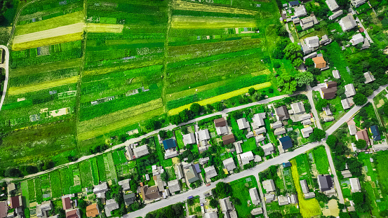 aerial detached idyllic town district property estate houses country side landmark scenic spring time field peaceful vivid green environment natural space