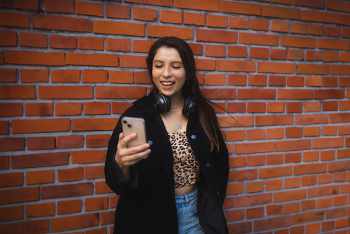 Young latin american woman using smartphone