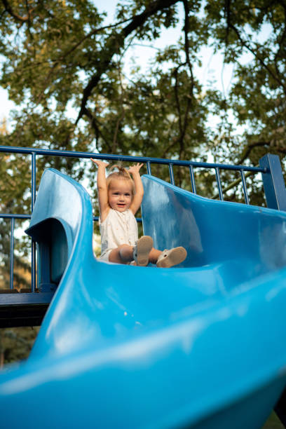 istock Excited girl sliding down the slide 1716773537