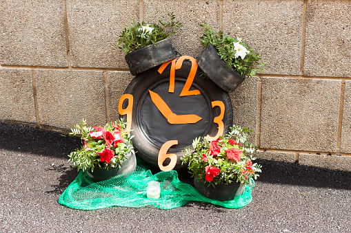 Clock made with car tires and flowers on Costitx en Flor (Costitx in bloom) Flower Fair, Majorca, Spain