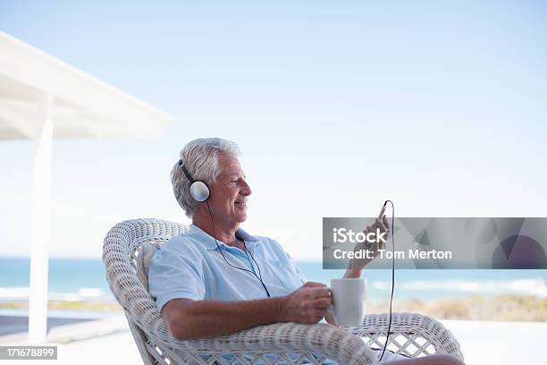 Senior Man Listening To Mp3 Player Stock Photo - Download Image Now - 60-64 Years, Active Seniors, Adult