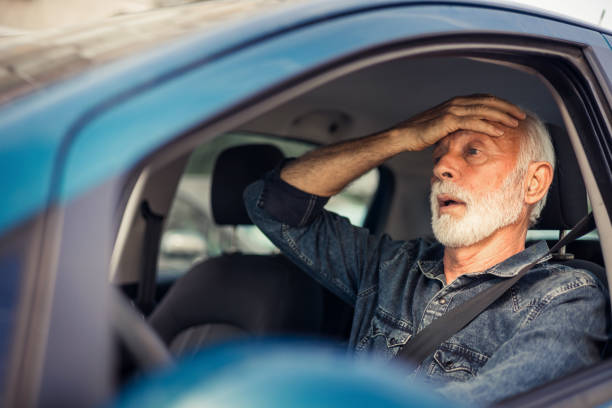 istock Angry man in the car yells at the driver in front. 1716798756