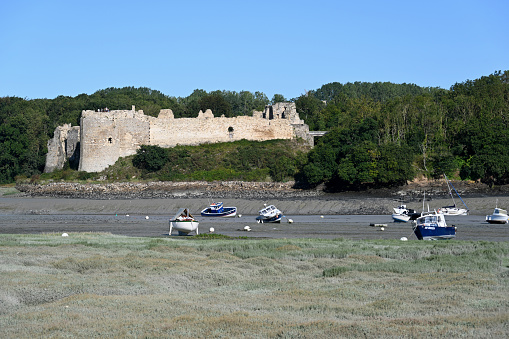 Saint-Cast-le-Guildo, Brittany, France, August 20, 2023 - Guildo castle or Chateau du Guildo on the dry riverbed of the Arguenon, Côtes d'Armor, Brittany.