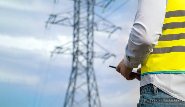 istock A male power engineer in a white helmet checks a power line using data from electrical sensors on a tablet. High voltage electrical lines at sunset. Distribution and supply of electricity. clean energy 1716813755