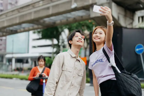 Young asian couple talking selfie photo with smartphone