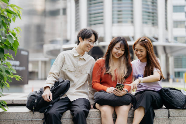 istock Young asian people using smartphone in the city 1716814966