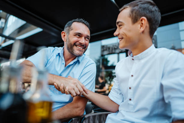 istock Father and son in a modern coffee bar or restaurant 1716816718