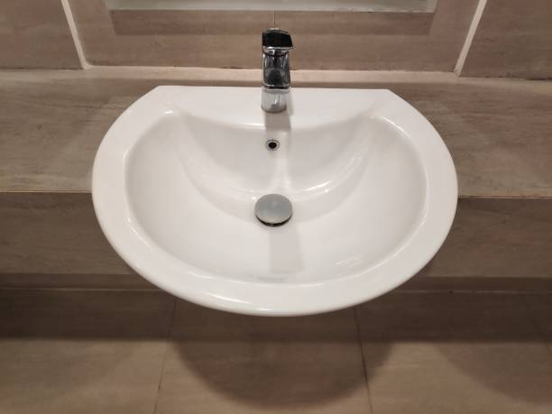 istock Round bathroom washing sink on marble stone surface 1716818981