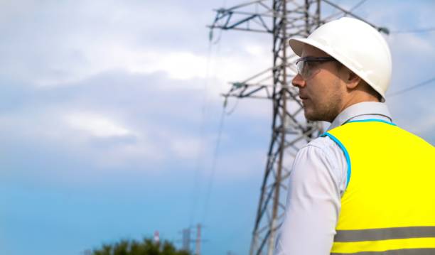 istock male engineer, power engineer in a helmet checks a power line using a tablet online. Electrician outdoors. High voltage electrical lines at sunset. Electricity distribution and supply 1716836649