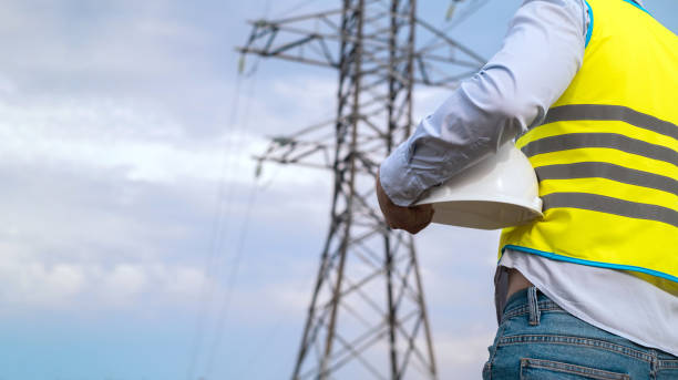 istock A male power engineer in a white helmet checks a power line using data from electrical sensors on a tablet. High voltage electrical lines at sunset. Distribution and supply of electricity. clean energy 1716836669