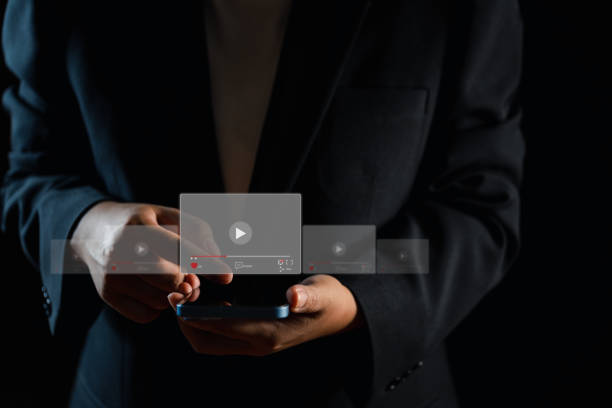 istock Mobile Multimedia Experience Woman Engaging with Video on Smartphone 1716846676