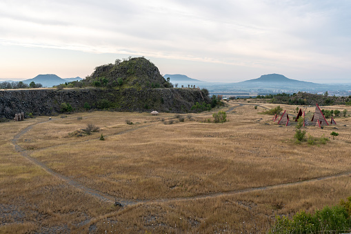 Abandoned basalt quarry with mountains in the background