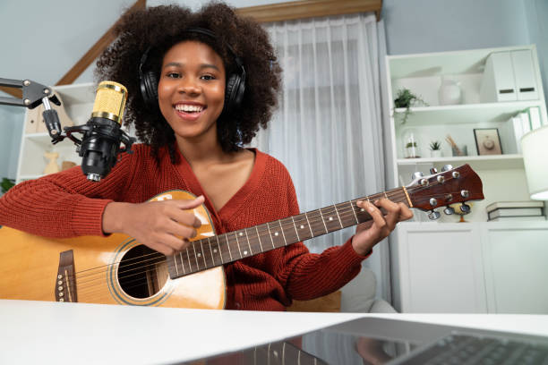 istock American African broadcasting on laptop with playing guitar. Tastemaker. 1716858222