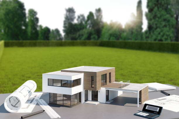 istock Model of a modern cubic house with planning drawings on a table 1716866720