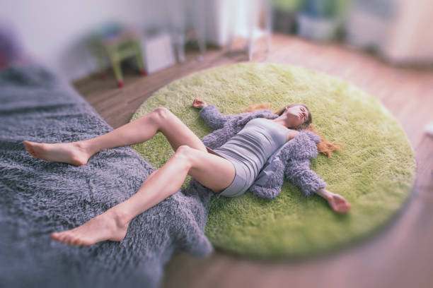 Woman relaxing with yoga at home. All logos, paintings and designs removed.