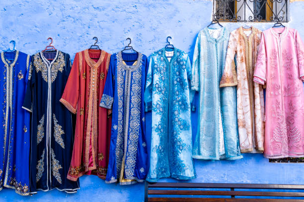 Traditional Moroccan women's outer outfit (djellaba) on sale hanging along a street in Chefchaouen, Morocco.