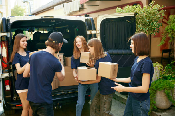 istock Young people, volunteers in uniform loading boxes into van. Gathering food, clothes, meds for people and animals in need 1716898070