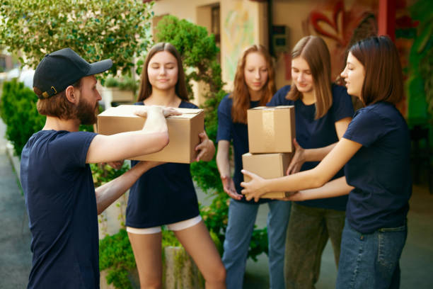 istock Helpful young people, volunteers gathering humanitarian help for people and animals. Loading boxes into van 1716898083