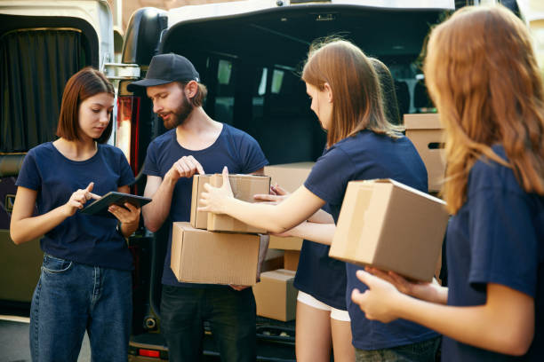 istock Young people, volunteers gathering humanitarian help for people and animals. Checking information and amount of boxes 1716898096
