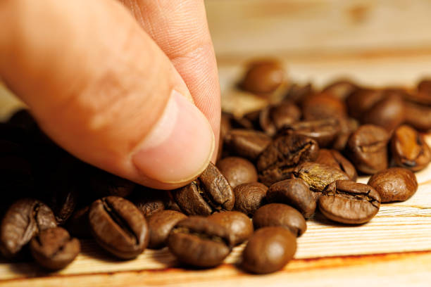 istock Coffee beans on a wooden table. 1716907098