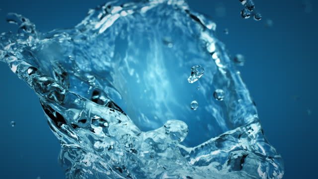 Pure clean water splash with droplets on blue background