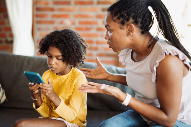 istock Small daughter is ignoring her mother and using cell phone at home 1716924600