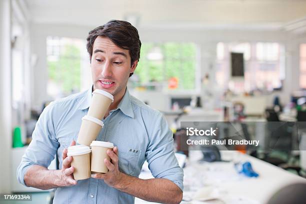 Businessman Balancing Coffee Cups Stock Photo - Download Image Now - Coffee - Drink, Carrying, Working