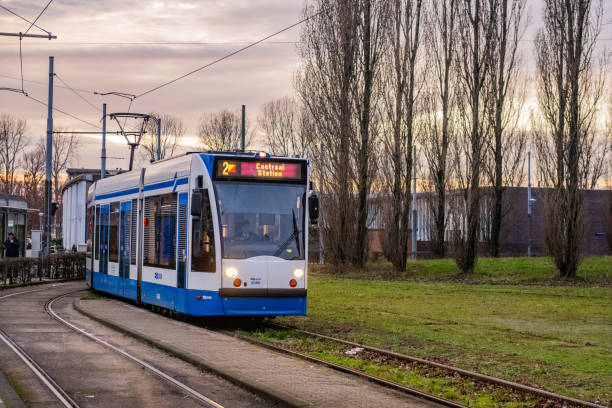 Amsterdam, the Netherlands. 16 March 2024. Line 2 Tram on a bridge in Amsterdam. it looks broken in two but it's the curve of the bridge.