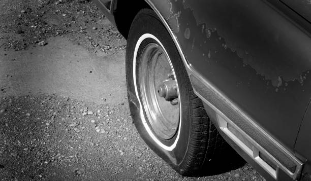 istock Flat Tire Red Car Vehicle Deflated 1716935750