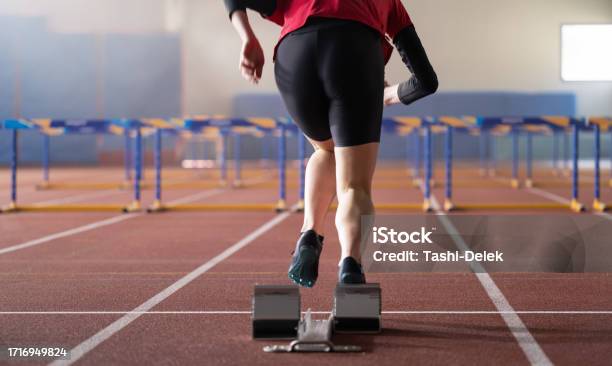 Female Runner Training And Jumping Over Hurdles Stock Photo - Download Image Now - Preparation, Speed, Slim