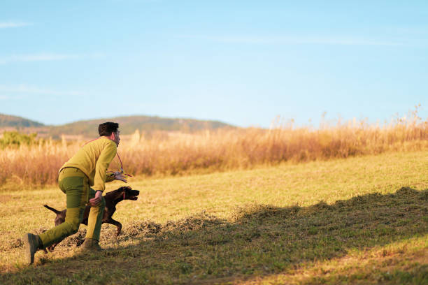 istock Beautiful  German Shorthaired Pointer dog and its owner during outdoors obedience training session.Man with hunting dog portrait. stock photo 1716962611