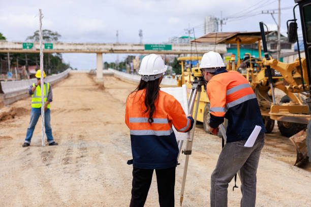istock Engineer use theodolite equipment for route surveying to build a bridge 1716964313