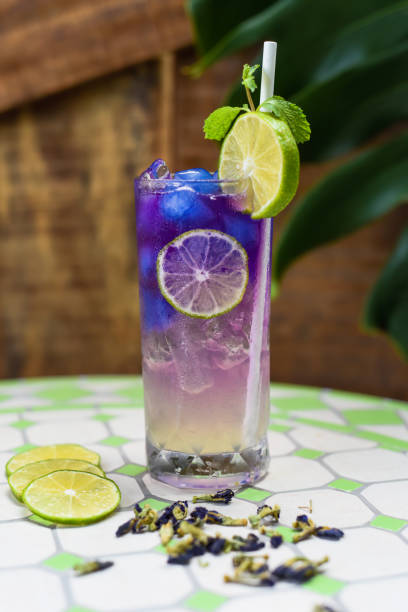 istock Lemonade with butterfly pea flowers and blue syrup on light gray background with copy space 1716974427